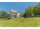 Expansive backyard with lush lawn, mature trees, and a view of the rear of the house at 4610 Admiral Ridge Way, Lilburn, GA 30047