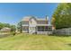 A wide, well-maintained backyard featuring a spacious lawn, a screened porch, and mature trees at 4610 Admiral Ridge Way, Lilburn, GA 30047
