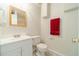 Bathroom with vanity, toilet, mirror and a red towel at 4610 Admiral Ridge Way, Lilburn, GA 30047