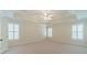 Spacious carpeted bedroom with tray ceiling, ceiling fan and two shuttered windows at 4610 Admiral Ridge Way, Lilburn, GA 30047