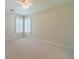 Bright bedroom with neutral carpet, ceiling fan and shuttered windows at 4610 Admiral Ridge Way, Lilburn, GA 30047