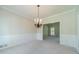 Bright dining room with neutral carpet, wainscoting, and a bronze chandelier at 4610 Admiral Ridge Way, Lilburn, GA 30047