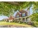 Beautiful brick home with a welcoming front porch, manicured landscaping, and attached two-car garage at 4610 Admiral Ridge Way, Lilburn, GA 30047