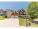 Lovely brick home with a two-car garage, inviting front porch, and lush landscaping, exuding classic elegance at 4610 Admiral Ridge Way, Lilburn, GA 30047