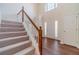 Bright foyer featuring a staircase, hardwood floors, and a view of the entrance at 4610 Admiral Ridge Way, Lilburn, GA 30047