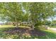 Charming home with lush landscaping, mature trees, and a welcoming front porch, creating a serene and inviting atmosphere at 4610 Admiral Ridge Way, Lilburn, GA 30047