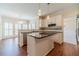 Well-lit kitchen with a center island, stainless steel appliances, and hardwood flooring at 4610 Admiral Ridge Way, Lilburn, GA 30047