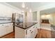 Functional kitchen with a center island, stainless steel refrigerator, and views into other rooms at 4610 Admiral Ridge Way, Lilburn, GA 30047