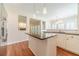 Open kitchen layout with a center island, stainless steel appliances, and hardwood floors at 4610 Admiral Ridge Way, Lilburn, GA 30047