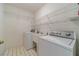 Well-organized laundry room features overhead shelving, utility sink, washer and dryer at 4610 Admiral Ridge Way, Lilburn, GA 30047