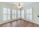 Bright living room features hardwood floors and plantation shutters for natural light at 4610 Admiral Ridge Way, Lilburn, GA 30047