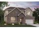 Charming two-story brick home with a well-manicured lawn and attached two-car garage providing great curb appeal at 7175 Brushwood Bend - Lot 36, Lithonia, GA 30058