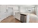 Open kitchen design with a kitchen island, stainless dishwasher, and a combined living and dining area at 7175 Brushwood Bend - Lot 36, Lithonia, GA 30058