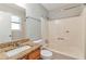Bathroom featuring a shower-tub combo, granite counters and a modern sink at 744 Martin Rd, Stone Mountain, GA 30088