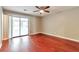 Bedroom featuring hardwood floors, a ceiling fan and sliding glass doors to the sunroom at 744 Martin Rd, Stone Mountain, GA 30088