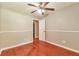 This bedroom boasts wood-look floors, a neutral color palette, and a ceiling fan at 744 Martin Rd, Stone Mountain, GA 30088
