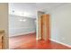 Bright dining room featuring hardwood floors and a modern chandelier lighting fixture at 744 Martin Rd, Stone Mountain, GA 30088