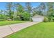 Exterior view of a house with a long driveway, a two-car garage and trees in the background at 744 Martin Rd, Stone Mountain, GA 30088