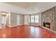 Comfortable living room includes stone fireplace, hardwood floors, and bright, natural light at 744 Martin Rd, Stone Mountain, GA 30088