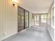 Enclosed sunroom features neutral paint and a sliding door to the home's exterior at 744 Martin Rd, Stone Mountain, GA 30088