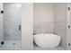 Modern bathroom featuring a soaking tub and frameless glass shower at 110 Hogue St, Atlanta, GA 30312