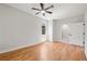 Bright bedroom with hardwood floors, ceiling fan, and access to the bathroom at 110 Hogue St, Atlanta, GA 30312