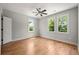 Bright bedroom with hardwood floors, a ceiling fan, and multiple windows at 110 Hogue St, Atlanta, GA 30312