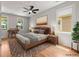 Comfortable bedroom with hardwood floors, ceiling fan, a modern bed, and windows for natural light at 110 Hogue St, Atlanta, GA 30312