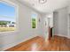 Hallway with hardwood floors, natural light, and stylish sconces leading to other rooms at 110 Hogue St, Atlanta, GA 30312