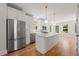 Modern kitchen with stainless steel appliances, white cabinetry, quartz countertops, and a kitchen island at 110 Hogue St, Atlanta, GA 30312