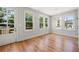 Bright room with beautiful hardwood floors, multiple windows, and access to the outdoor deck at 110 Hogue St, Atlanta, GA 30312
