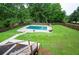 Backyard with a fenced in swimming pool, patio and grassy area, providing ample space for outdoor recreation and relaxation at 409 Cold Springs Ln, Mcdonough, GA 30252