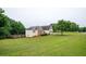 Expansive backyard with lush green lawn, mature trees, and serene surroundings create a private outdoor retreat at 409 Cold Springs Ln, Mcdonough, GA 30252