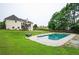 Swimming pool with patio and lush green grass with deck and a two story home in the background at 409 Cold Springs Ln, Mcdonough, GA 30252