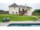 Swimming pool and backyard featuring a two-story home, patio seating, and a grassy area perfect for summer fun at 409 Cold Springs Ln, Mcdonough, GA 30252