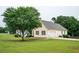 Spacious backyard with lush lawn, mature trees, and a two-car garage for outdoor enjoyment and convenience at 409 Cold Springs Ln, Mcdonough, GA 30252