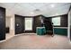 Finished basement with carpet, painted walls and a treadmill next to a window at 409 Cold Springs Ln, Mcdonough, GA 30252