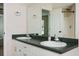 Bathroom featuring a double sink vanity with a large mirror and a shower with a glass door at 409 Cold Springs Ln, Mcdonough, GA 30252