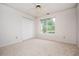 Bright bedroom with a window, double closet, and neutral carpeting for a cozy feel at 409 Cold Springs Ln, Mcdonough, GA 30252