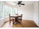 Bright dining area with wood floors, a round table, and large windows at 409 Cold Springs Ln, Mcdonough, GA 30252