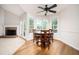 Bright dining area with wood floors, a round table, and fireplace at 409 Cold Springs Ln, Mcdonough, GA 30252