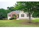Charming one-story home featuring a brick accent, well-maintained lawn, and mature trees enhancing curb appeal at 409 Cold Springs Ln, Mcdonough, GA 30252