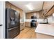 Efficient kitchen featuring stainless steel appliances, updated countertops, and ample cabinet space at 409 Cold Springs Ln, Mcdonough, GA 30252