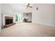 Bright living room with a fireplace, ceiling fan and access to outdoor patio through sliding glass doors at 409 Cold Springs Ln, Mcdonough, GA 30252