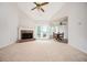Bright living room with a fireplace, ceiling fan and access to outdoor patio through sliding glass doors at 409 Cold Springs Ln, Mcdonough, GA 30252