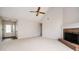 Living room featuring a fireplace, ceiling fan and access to entry at 409 Cold Springs Ln, Mcdonough, GA 30252