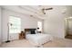 A cozy main bedroom with a tray ceiling, ceiling fan, and neutral decor at 409 Cold Springs Ln, Mcdonough, GA 30252
