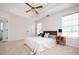 A cozy main bedroom with a tray ceiling, ceiling fan, and neutral decor at 409 Cold Springs Ln, Mcdonough, GA 30252