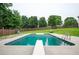 Backyard swimming pool featuring a diving board, ladder, pool furniture, patio and an enclosed fence at 409 Cold Springs Ln, Mcdonough, GA 30252