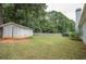 Spacious backyard with storage shed, providing a large area for outdoor enjoyment at 704 Stonecrest Ln, Loganville, GA 30052